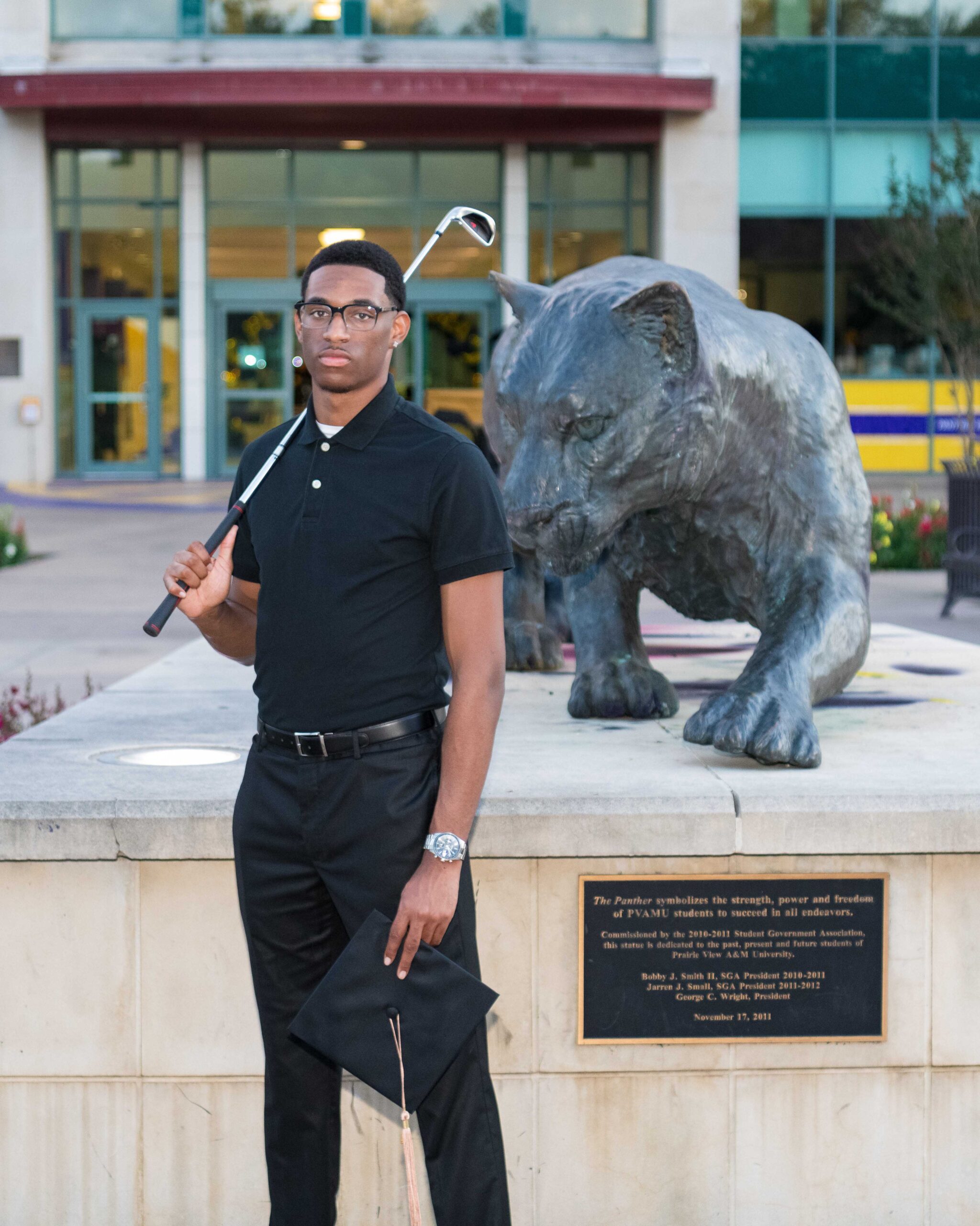 College grad posing for grad photos at PVAMU