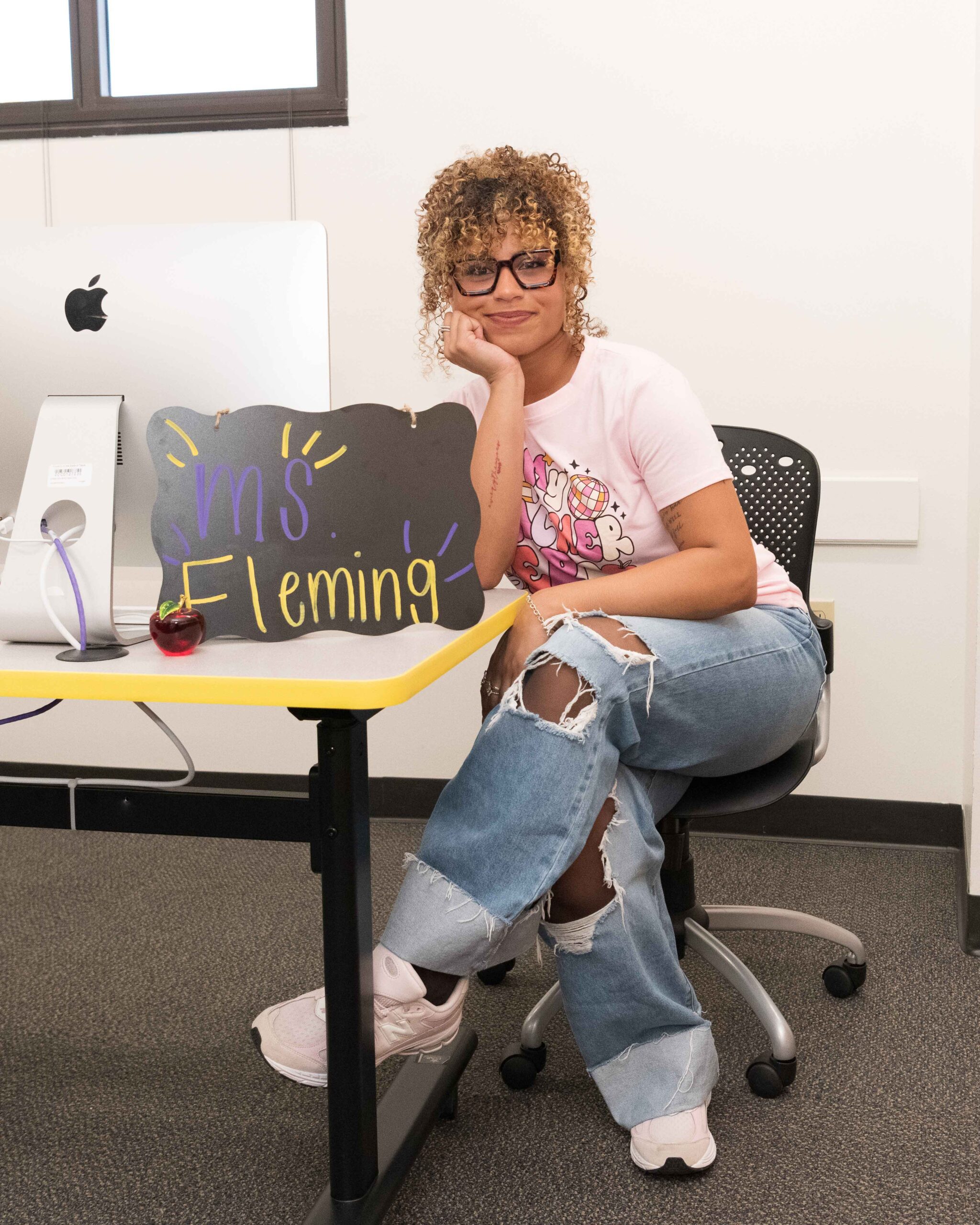 College grad posing for grad photos at PVAMU