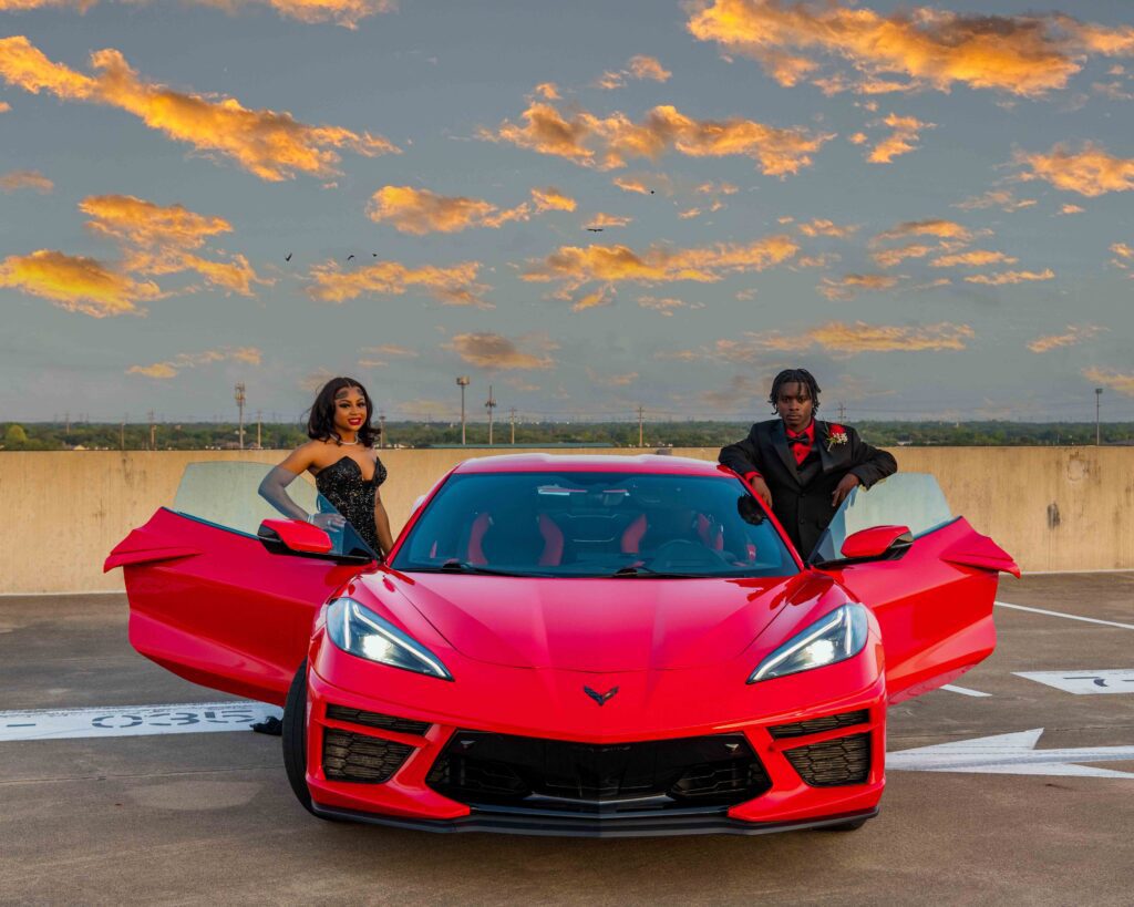 Smilestones Photography prom session in Katy TX featuring a red Corvette and sunset.